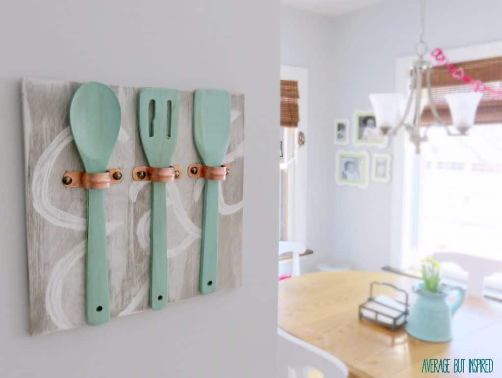 Average But Inspired shows you how to make unique art for your kitchen using copper pipe straps, wooden utensils and some paint!